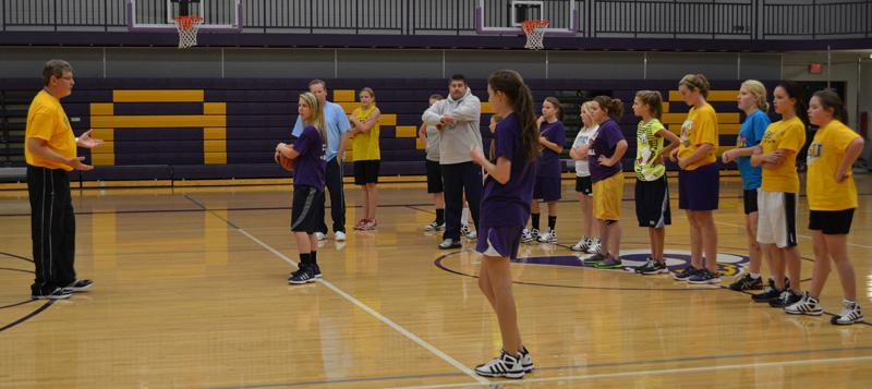 Varsity+girls+basketball+coach+Frank+Decker+helps+the+junior+high+girls+team+learn+new+plays.+