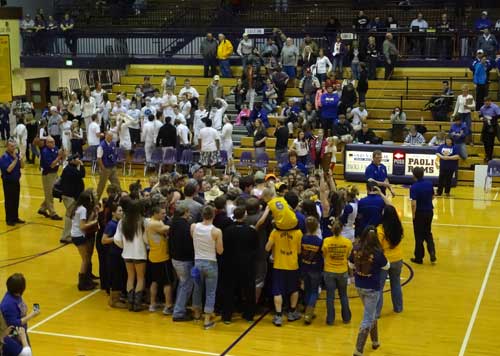 The cheer block storms the court after the girls take sectional.
