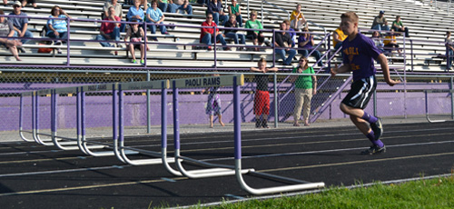 Eighth grader Keegan Stephens racing in 100 meter hurdles running event. 