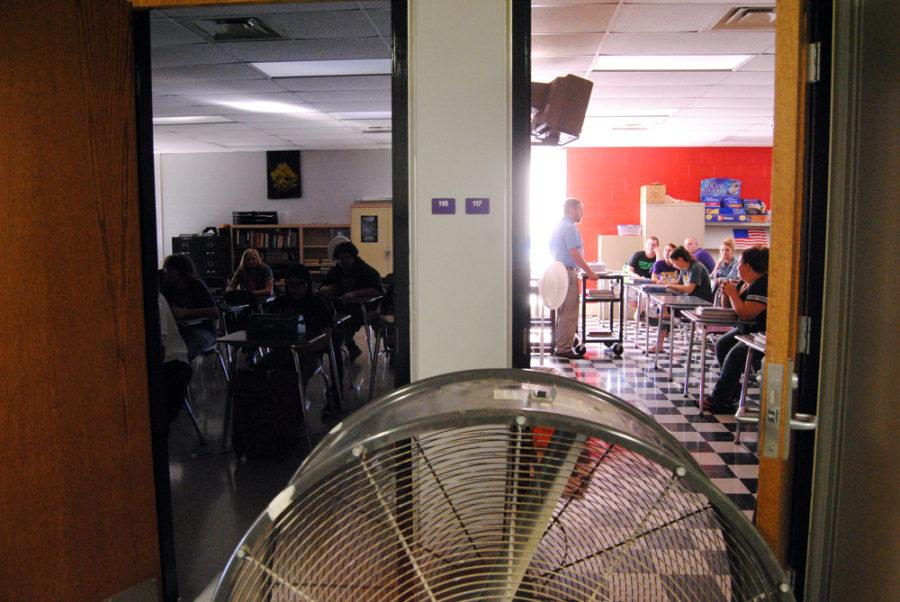 Social+Studies+teachers+Neil+Dittmer+and+Scott+Gudorf+use+a+industrialized+fan+to+cool+off+students+today+in+class+due+to+air+conditioning+issues.
