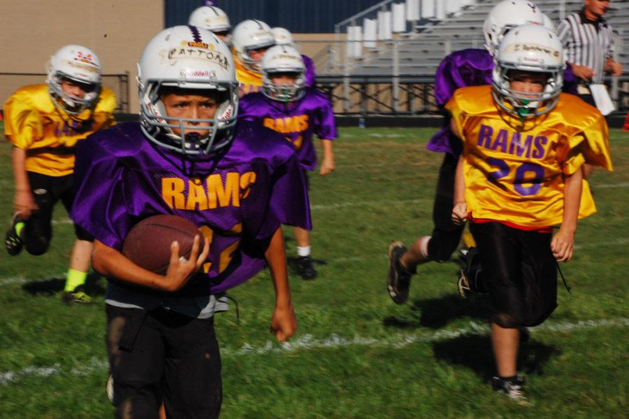 Fourth+grader+Bladen+Patton+runs+the+ball+for+a+purple+touchdown.