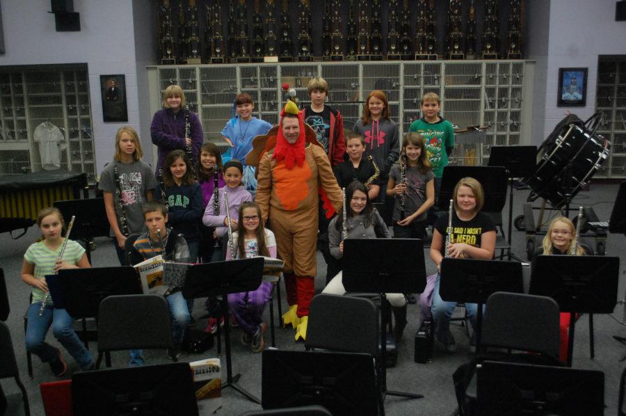 Music teacher, Bill Laughlin takes a picture with his 5th grade band class.