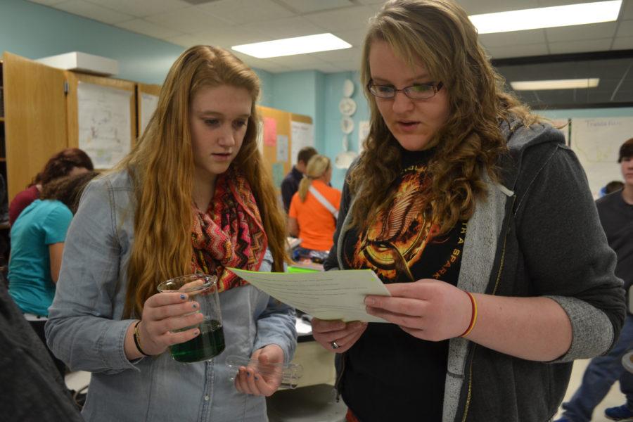 Freshmen Jaylin Busick and Leitha Levi read the procedures during a biology lab in Mrs. Higgins Biology 1 class. 