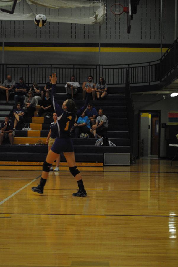 Freshman Ashley Archer goes up for a serve in the JV volleyball game against Salem. 