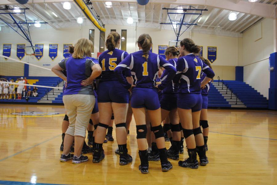 Varsity volleyball huddle in for a pep talk. 
