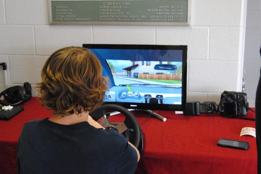Freshman Matt Agan tests out a driving simulator during lunch. 