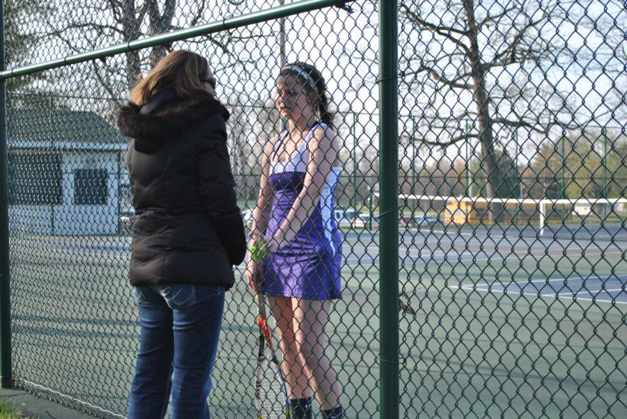 Freshmen Emma Osborn, talking to coach before her tennis match.