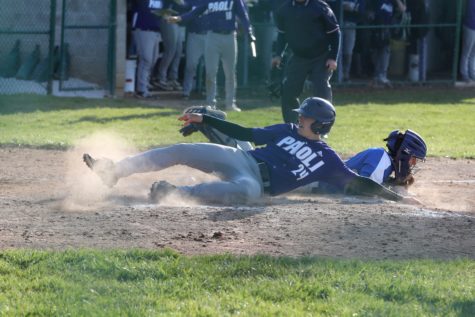 Junior Trey Rominger slides at home during a home game last year.