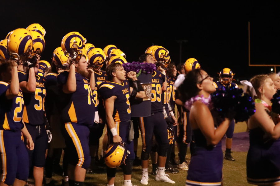 The football team sings the fight song with the Ram Can after their first win on their home field.