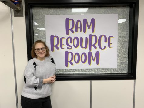 Librarian Rachel Miller poses with her Ram Resource Room sign.