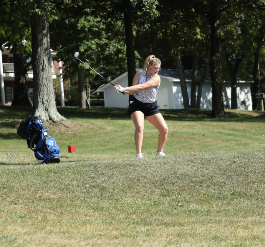 Senior Ryleigh Anderson hits a golf ball to start off the meet.