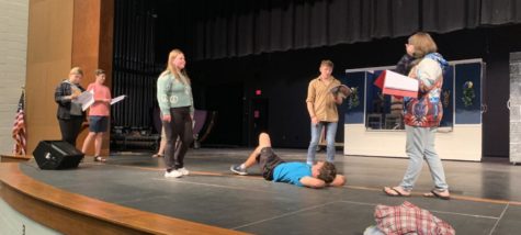 Drama students run through their scripts during a play practice.