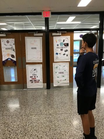 Sophomore Brian Fullington looks at the banners made by 
each of the homerooms hanging outside of the cafeteria. 