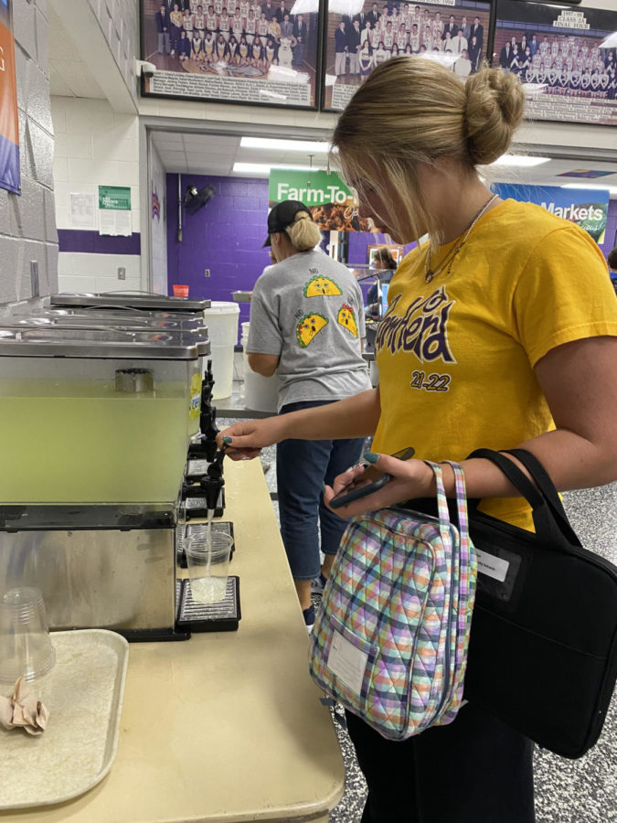 Senior Jackie Crews fills up her cup with lemonade from the drink station before eating. 