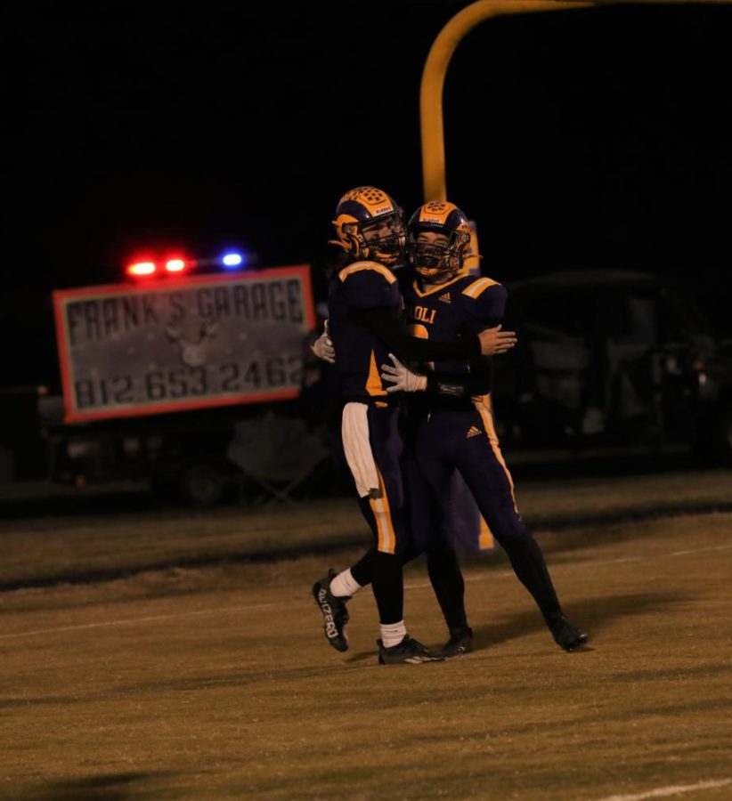 Senior Braxton Elliott and sophomore Garrett Hickman hug after a touchdown.