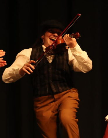 Senior Ellie Sims dances around the stage as the fiddler.