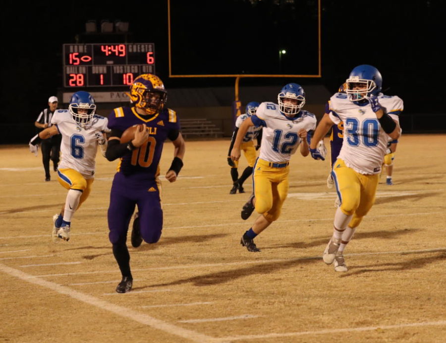 Senior Brandon Cook runs the ball down the field into the endzone.