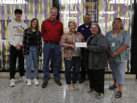 (From left to right) Willson, Stella, and William Windhorst, pose with Varsity Volleyball Coach Alexis Speer and Principal Ed Wagner, as she presents a check to Norma Free and Robin Brown, representatives from Orange County Cancer Patient Services.