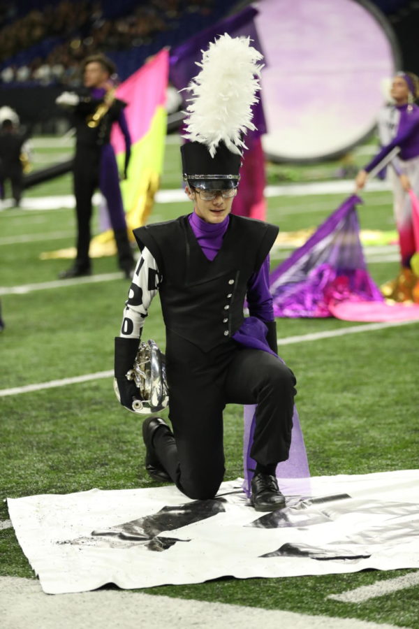 Junior Braeden Campbell kneels during the beginning of part four of the show. The musicians performed lots of 
choreography during their show.