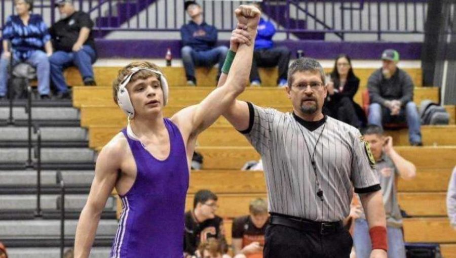 Benales holds his hand high after a win. This match marked 
his second conference title as a sophomore 
in 2020.