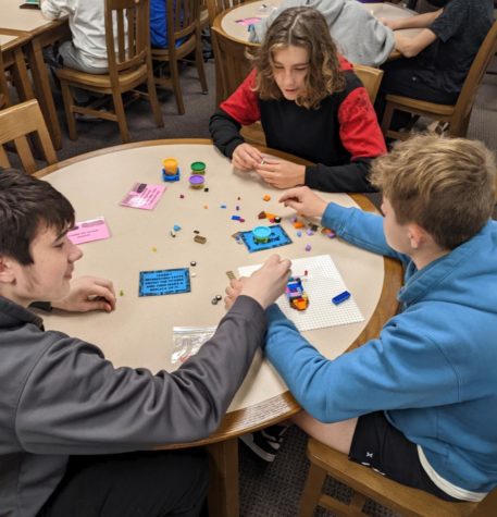 Students play games in the Makerspace area in the library.