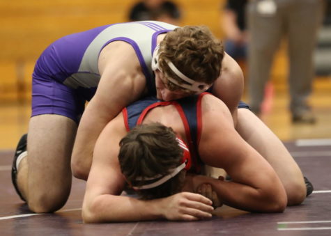 Senior Marty Higgins holding his opponent on the ground.