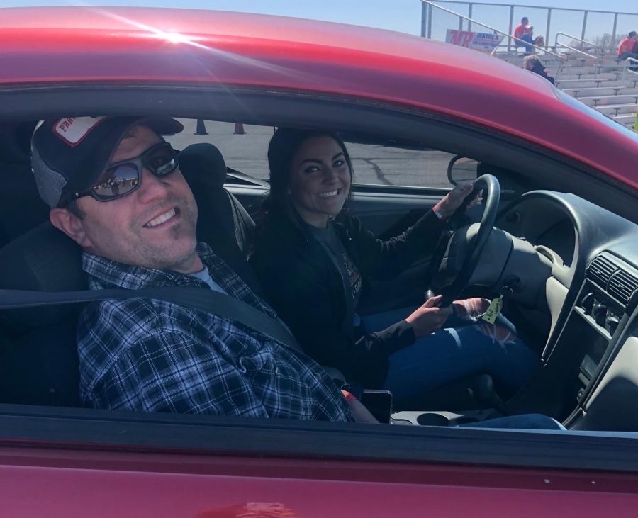 Junior Maddi Warren and her father Frank Warren smile for a picture in Warrens car.