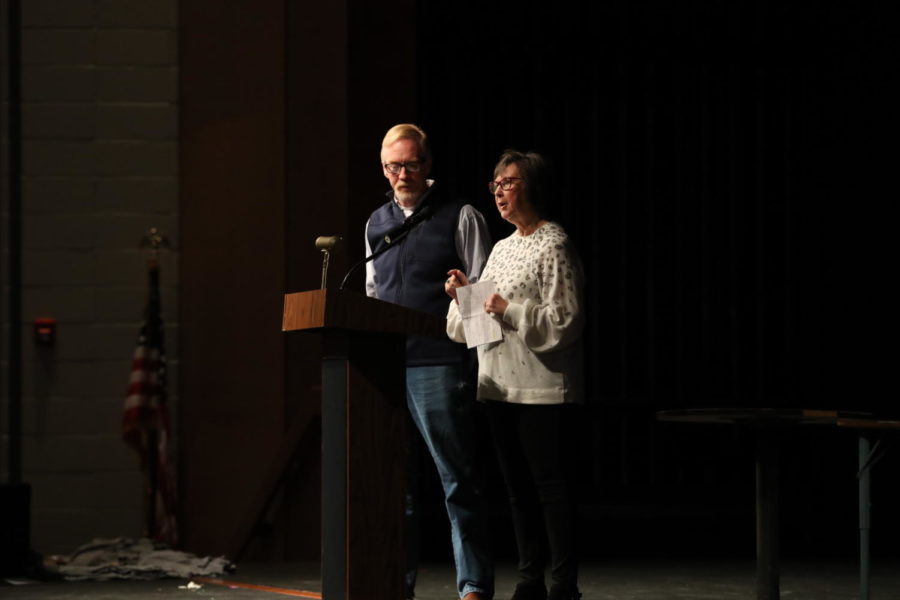 Early Release Coordinator Chris Lindley listens as School Board President Lila Tucker gives tips for the Peddler’s Market.