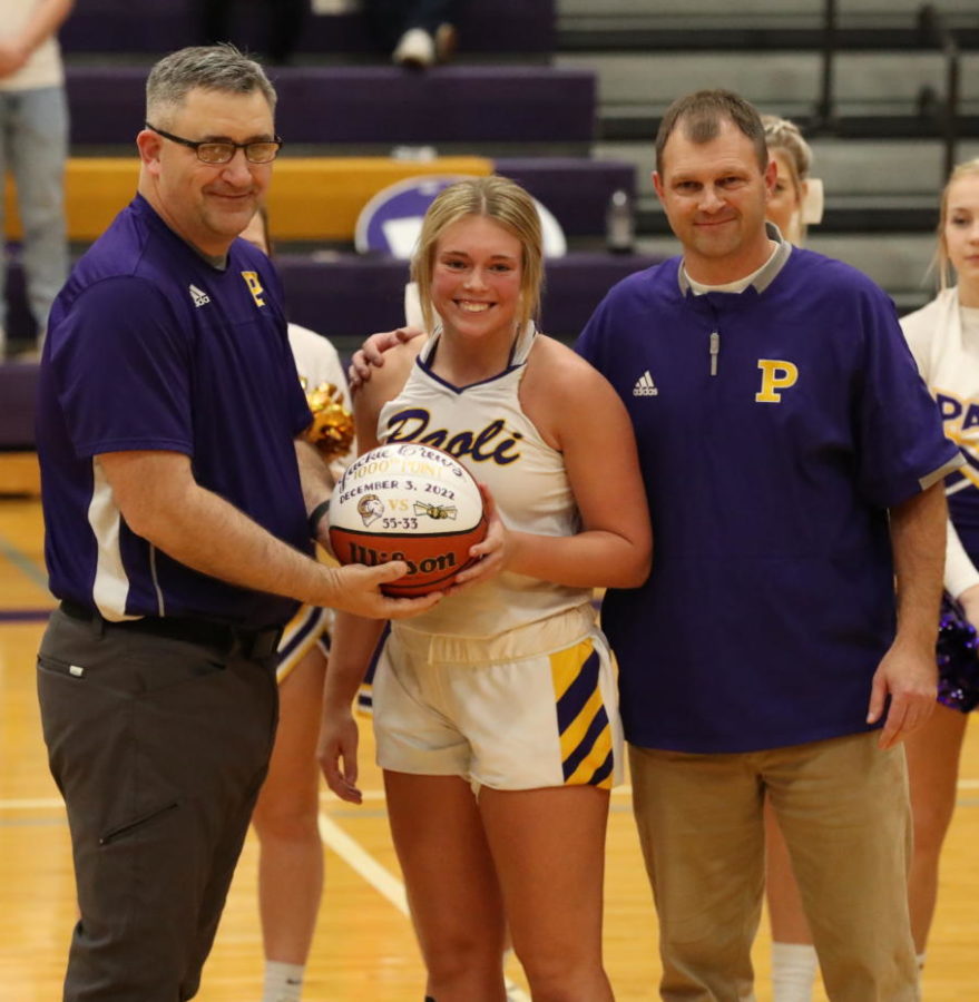 Senior Jackie Crews poses with Athletic Director Derek Newkirk and Varsity Head Coach Donavan Crews after being presented her ball for scoring over 1000 points.