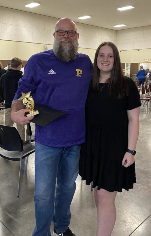 Art Teacher Chris Jones stands with junior Olivia McSpadden after receiving an award at the ceremony. McSpadden nominated Jones for the honor.