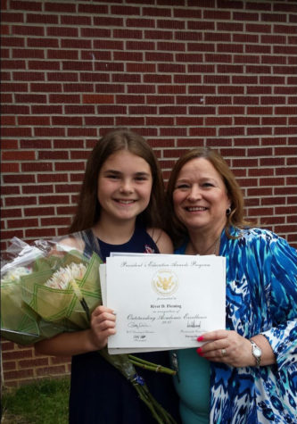 Fleming poses with her grandmother after graduating the sixth grade in 2017. 