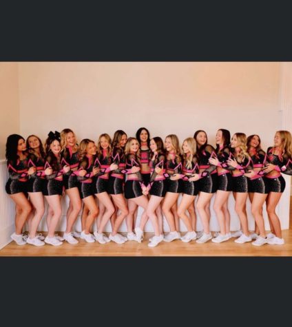 Freshman Kailynn Larimore poses with her competitive cheer team.