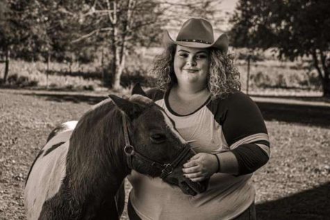 Senior McKali Hedge poses with her horse.
