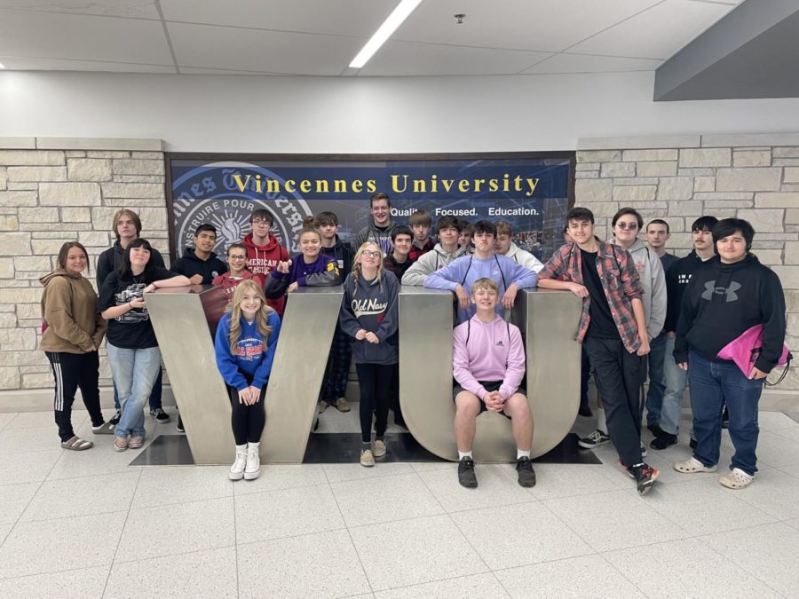 A group of sophomores pose in front of the Vincennes University Statue during the campus tour.