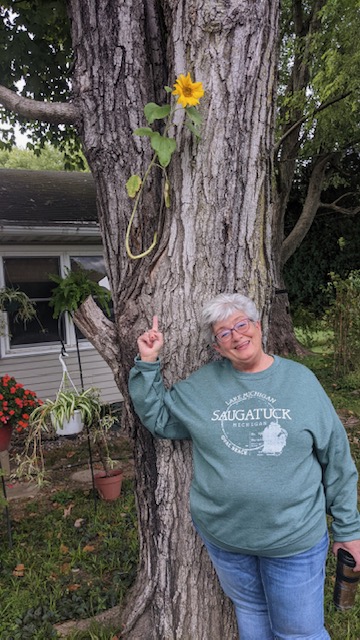 Study Hall teacher Barb Grabner poses with a tree.