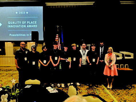Members of the construction class pose after being awarded the Quality of Place Innovation Award by Regional Opportunities Initiative. Pictured with award representatives are (from left) Construction Teacher Jon Shellenberger, Luke Oldham, Jareth Nunez, William Baker, Ashton Jones, Isaiah Apple, William Bottoms and Luke Baxter.