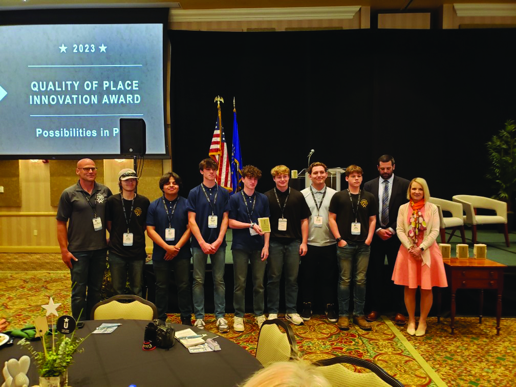 Members of the construction class pose after being awarded the Quality of Place Innovation Award by Regional Opportunities Initiative. Pictured with award representatives are (from left) Construction Teacher Jon Shellenberger, Luke Oldham, Jareth Nunez, William Baker, Ashton Jones, Isaiah Apple, William Bottoms and Luke Baxter.