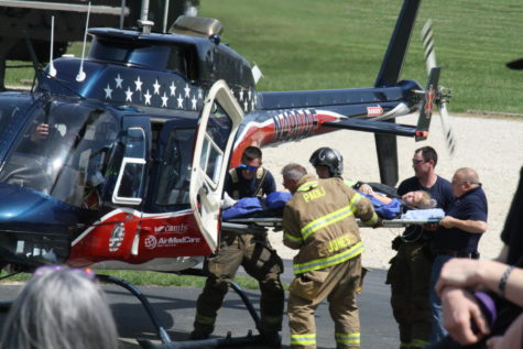 Senior Cailyn Baechle awaits transport during the Mock Crash.