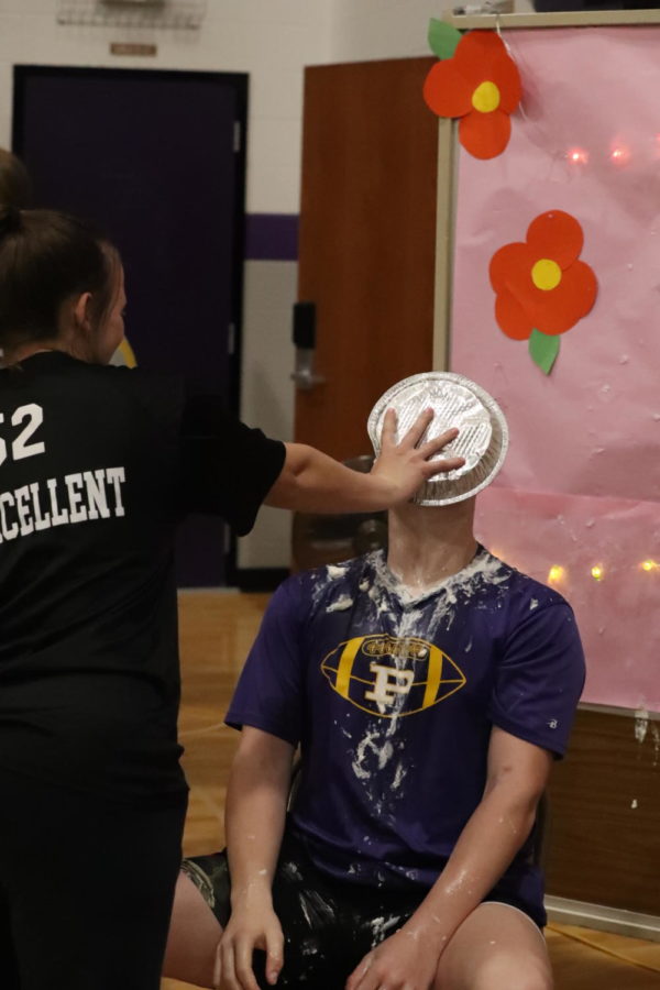 Junior Gracie Brown pies sophomore Jaxson Reynolds in the face during her homerooms booth.