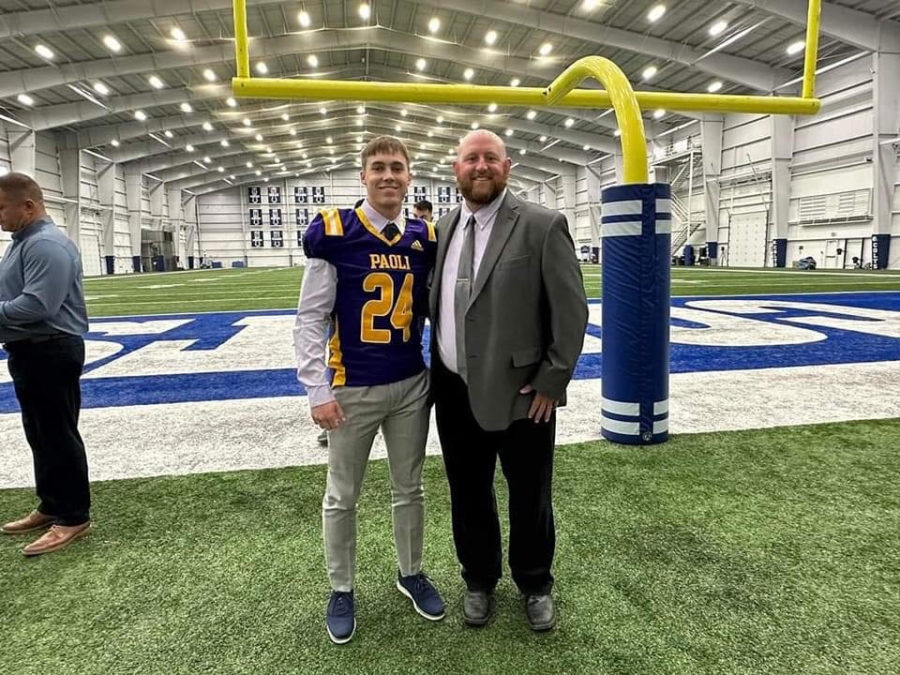 Coach Neil Dittmer poses with Trey Rominger at the Colts field.