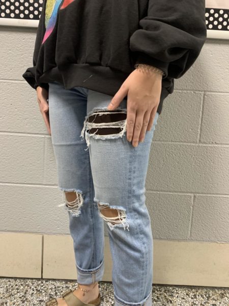 Student in dress code approved clothing poses for picture