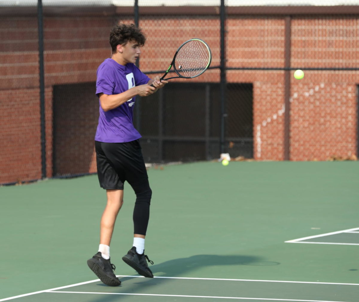Sophomore Kirk Hughes hits a ball during a match early in the season.