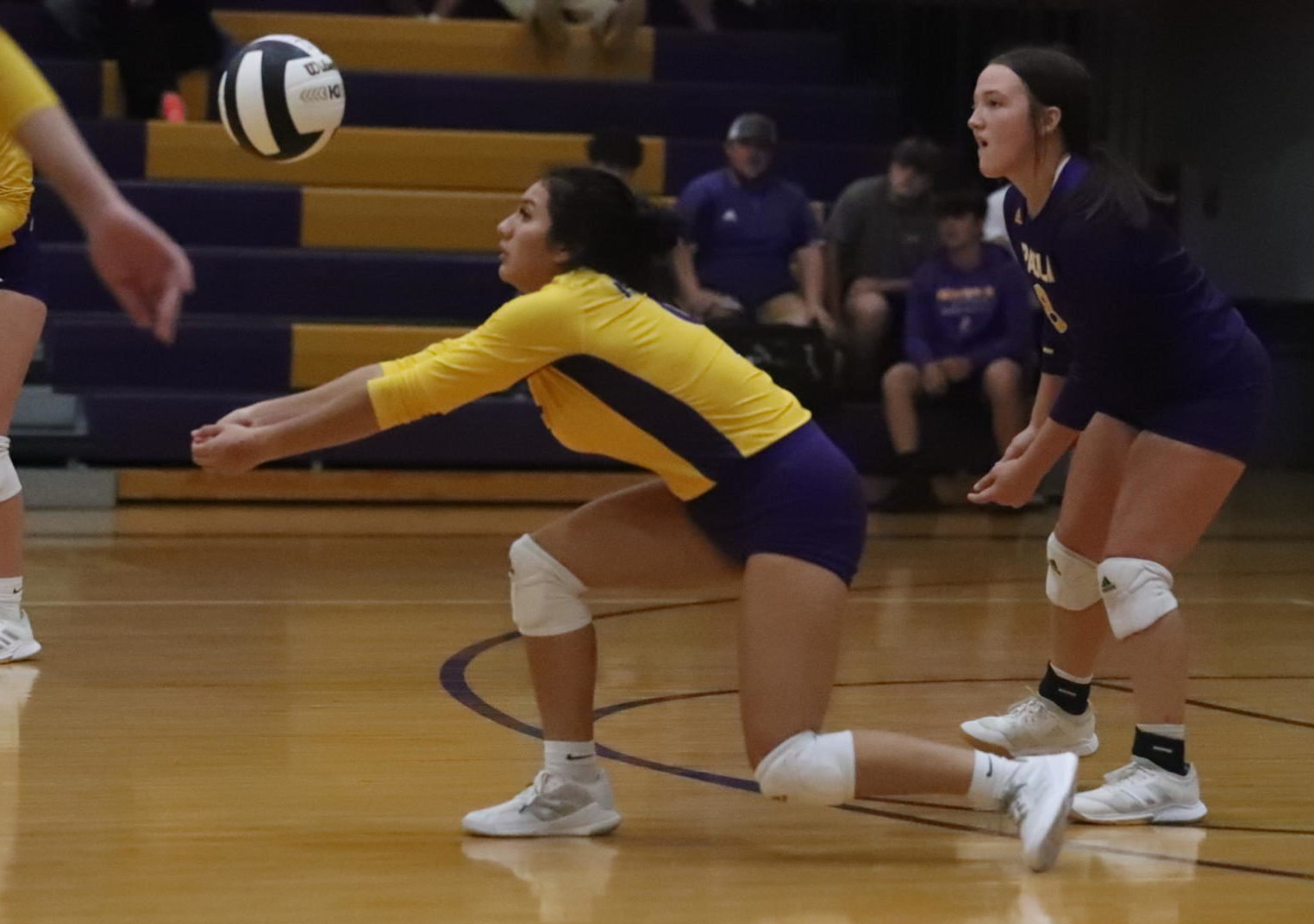 Senior Nadia Garcia goes for a ball with fellow senior Gracie Brown watching the play.