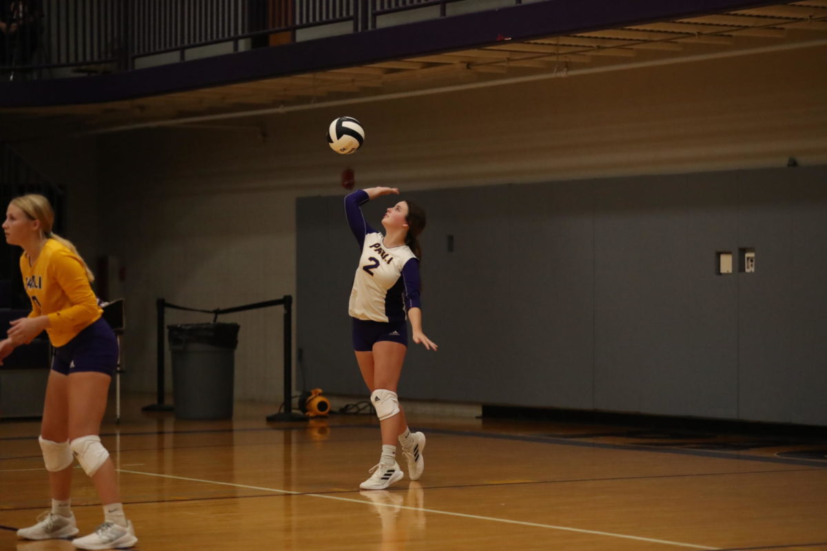 Junior Lilly Hall serves the ball.
