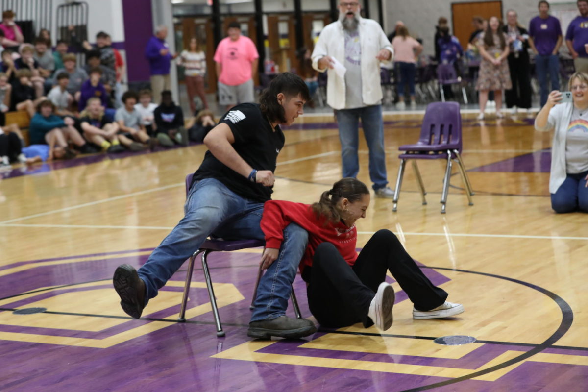 Freshman Rusty Turner and senior Lily Stroud compete in musical chairs.