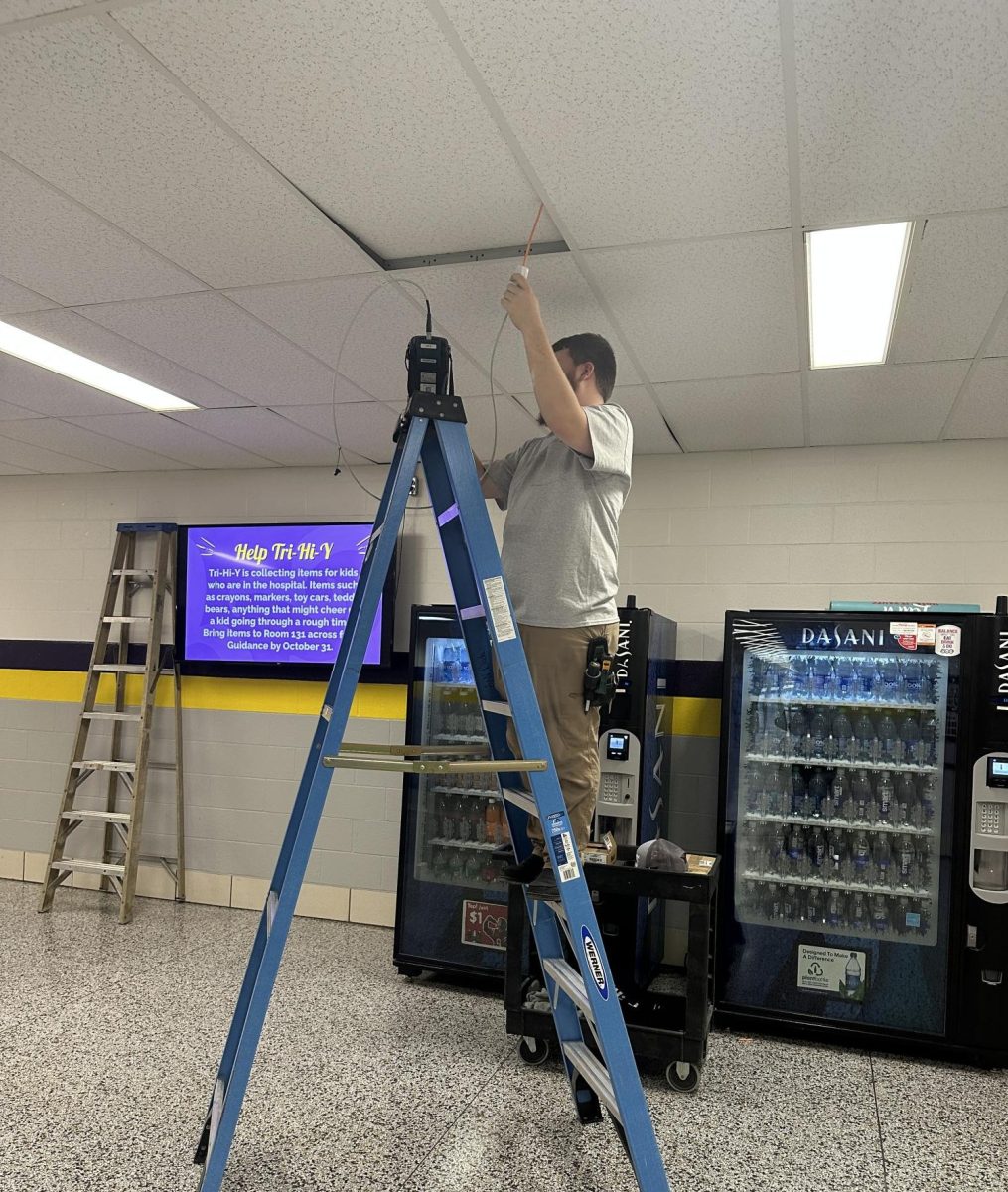 A worker installs one of the new cameras.
