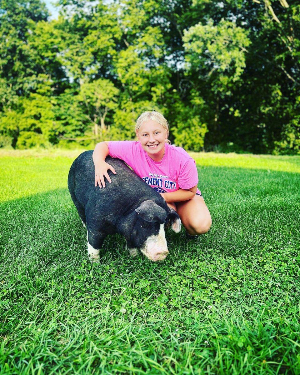 Junior Chloe Smith posing with her pig.
