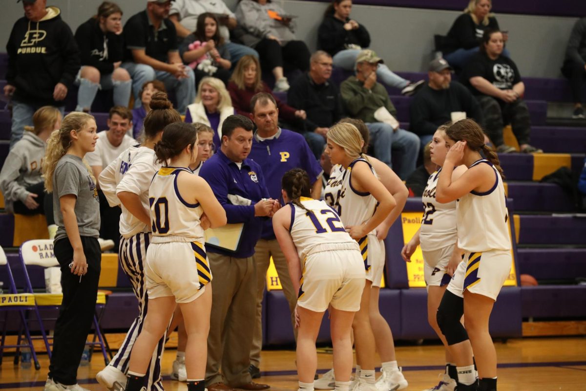 Sophomore Maddie Vernon (pictured far left) standing in the huddle.