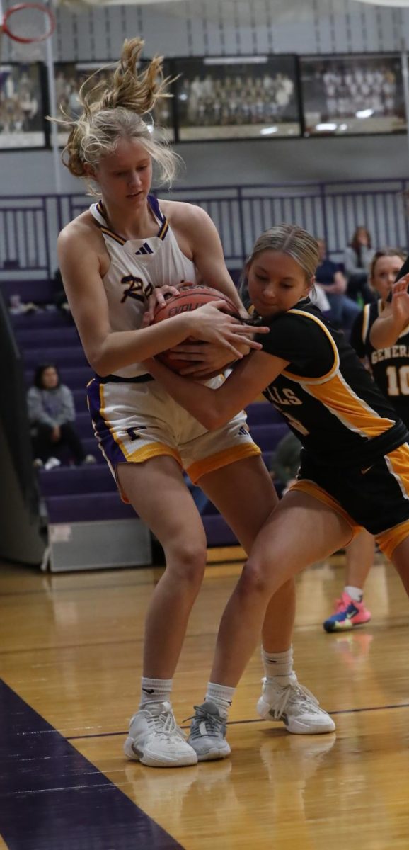 Carley Higgins fights for the ball.