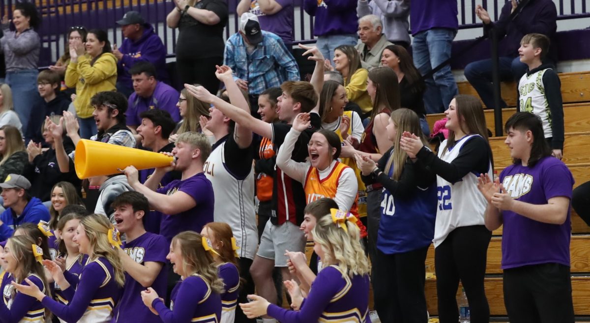 Booster Club cheers after senior Jason Beavers first three of the season.